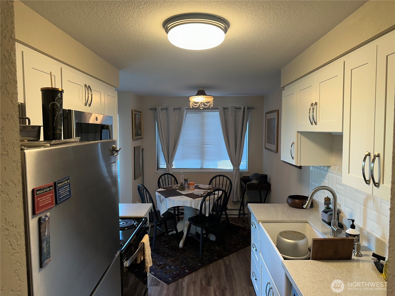 2232 Northwest 58th Street Seattle, WA 98107 - Photo 10 of 21 a kitchen with stainless steel appliances granite countertop sink stove and refrigerator