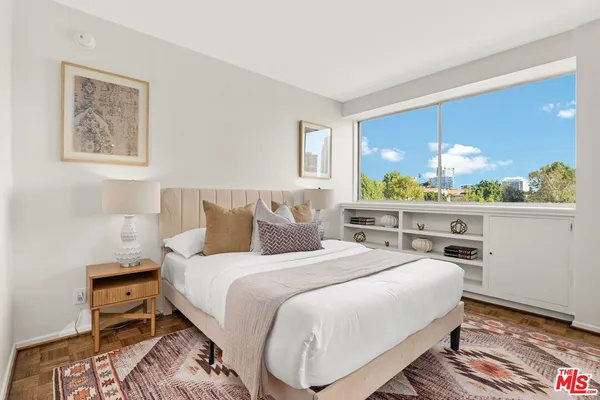 a bedroom with bed and a window