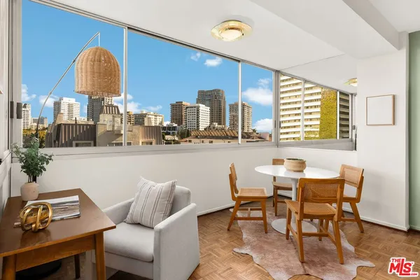 a view of a dining room with furniture and a window