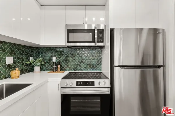 a kitchen with a refrigerator and a sink