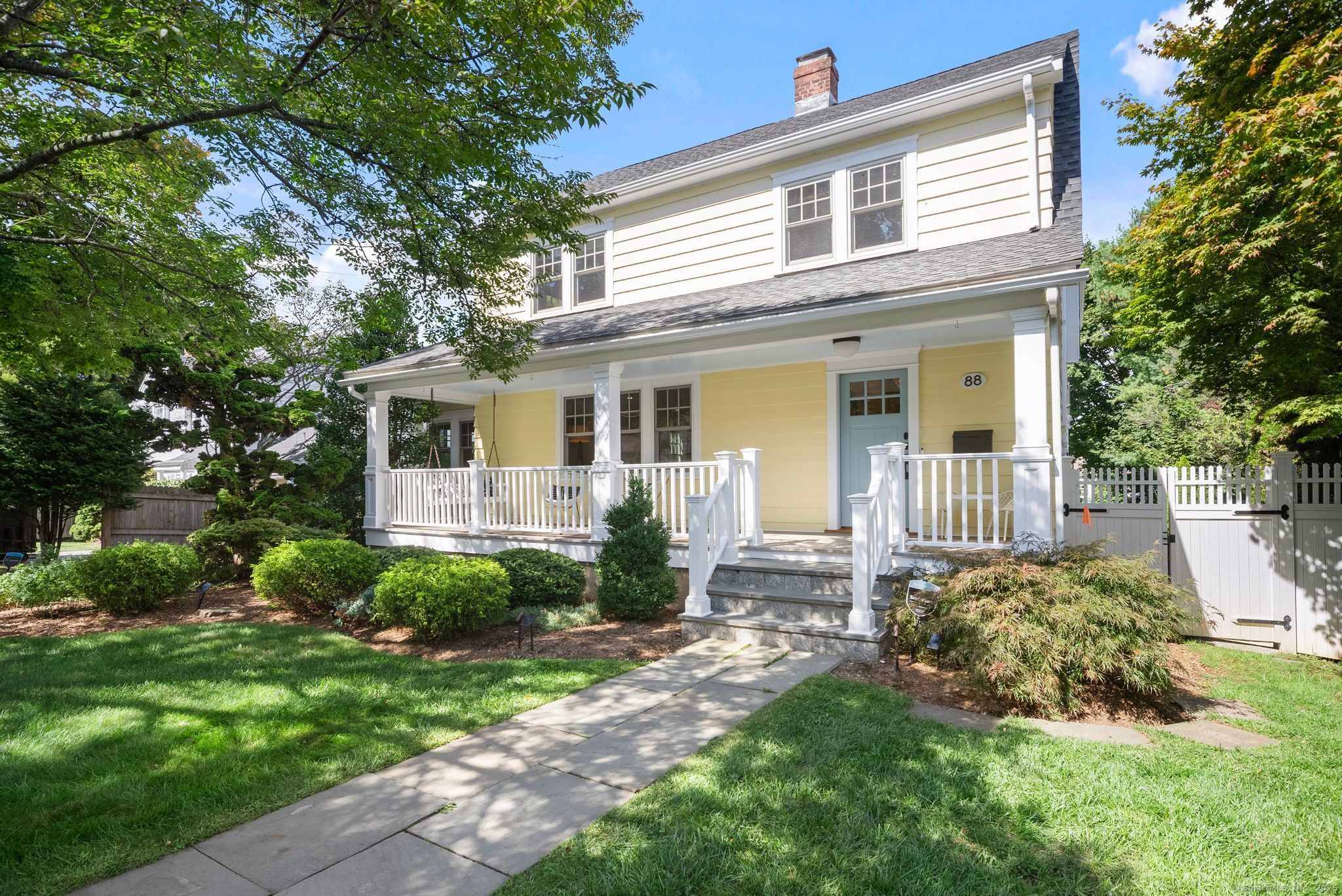88 Overhill Road Fairfield, CT 06824 - Photo 2 of 37 a front view of a house with a yard and outdoor seating