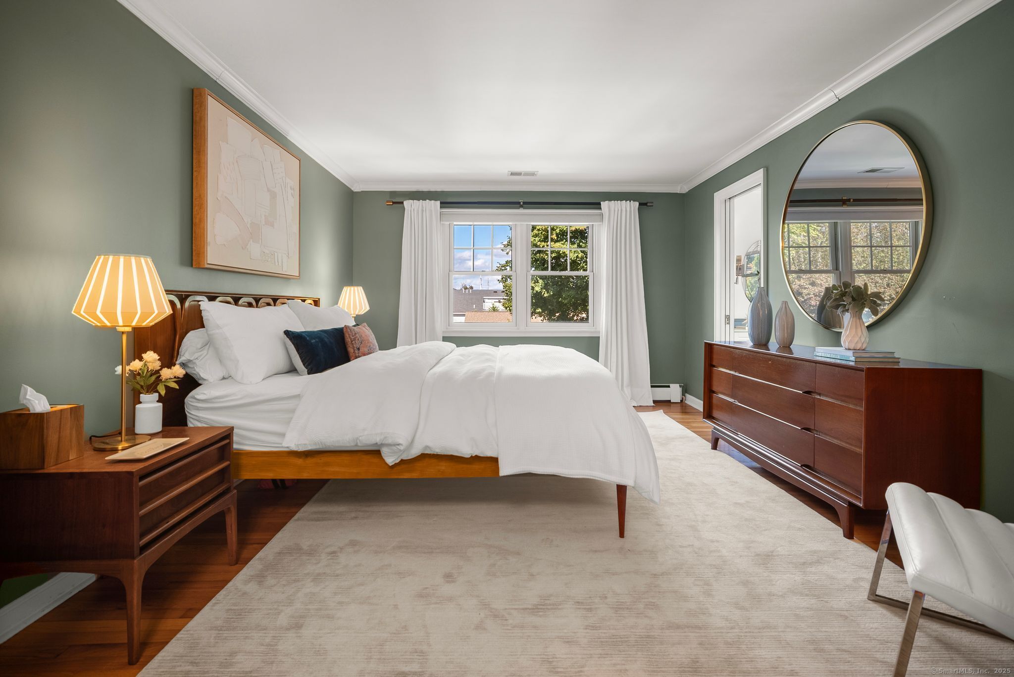 88 Overhill Road Fairfield, CT 06824 - Photo 22 of 37 a bedroom with a bed mirror on dresser and a wooden floor