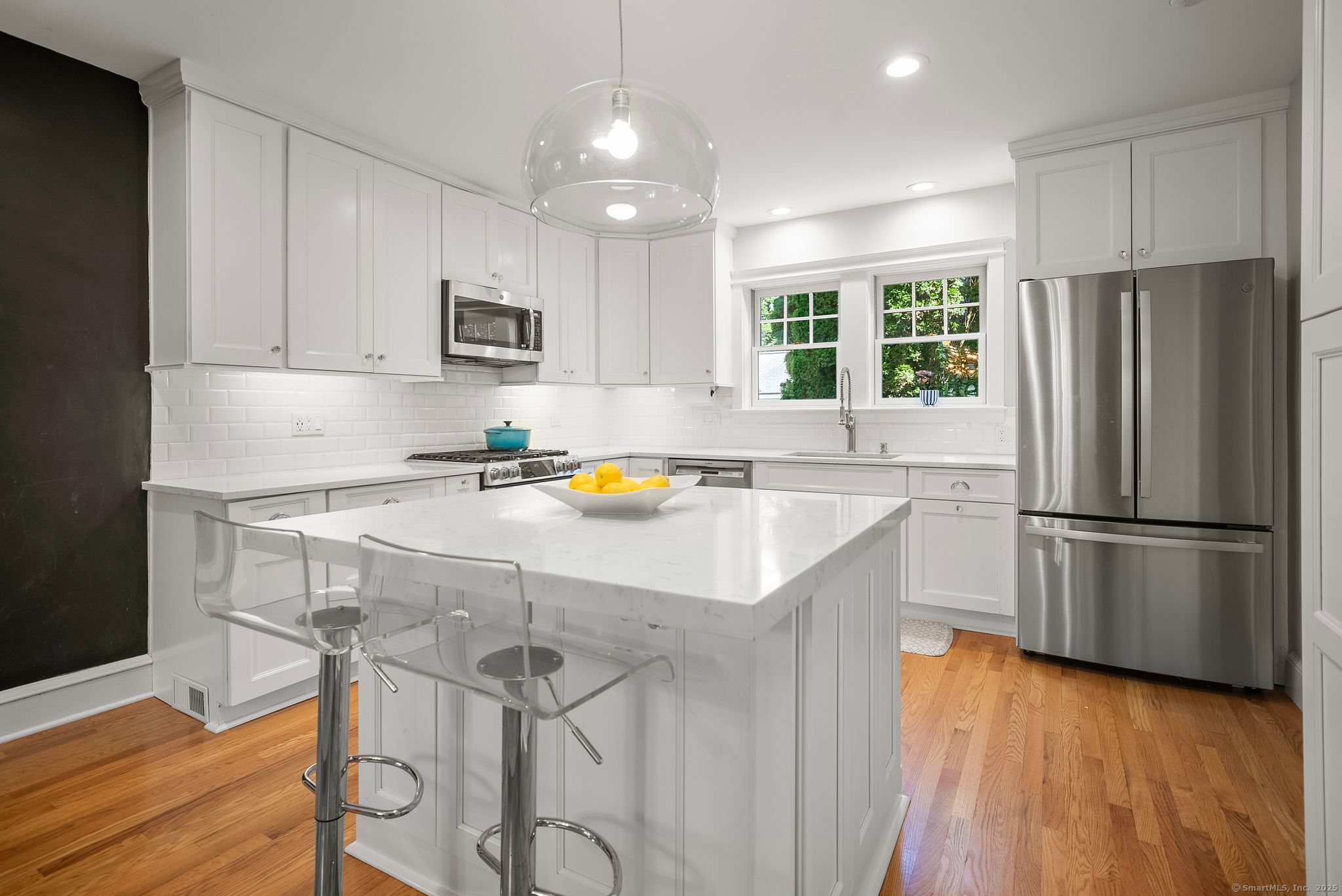 88 Overhill Road Fairfield, CT 06824 - Photo 10 of 37 a kitchen with stainless steel appliances a refrigerator a sink a stove a microwave and wooden cabinets