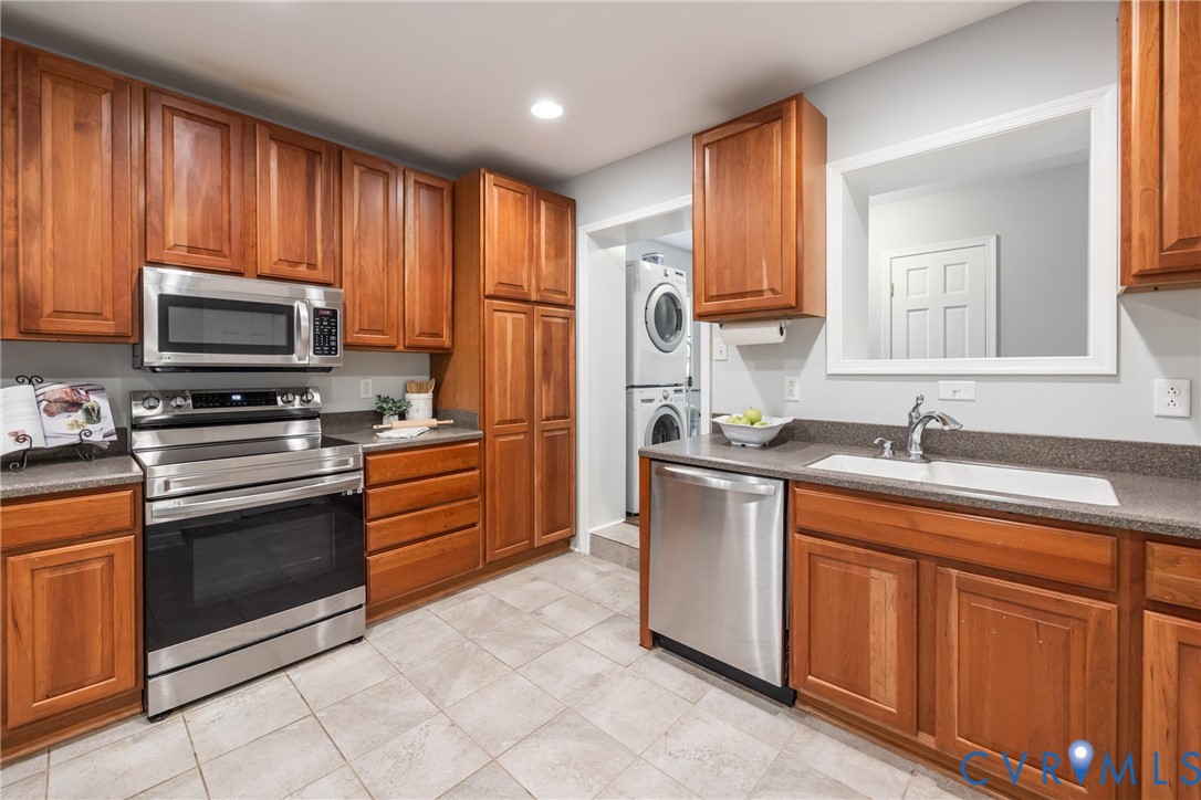 795 Snead Road Manakin-Sabot, VA 23103 - Photo 17 of 31 a kitchen with stainless steel appliances granite countertop wooden cabinets a stove top oven a sink and dishwasher