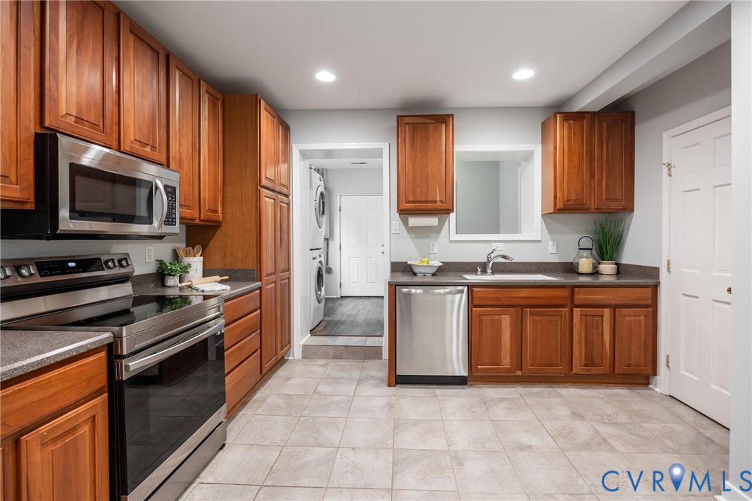 795 Snead Road Manakin-Sabot, VA 23103 - Photo 19 of 31 a large kitchen with stainless steel appliances granite countertop wooden cabinets a stove top oven a sink and dishwasher