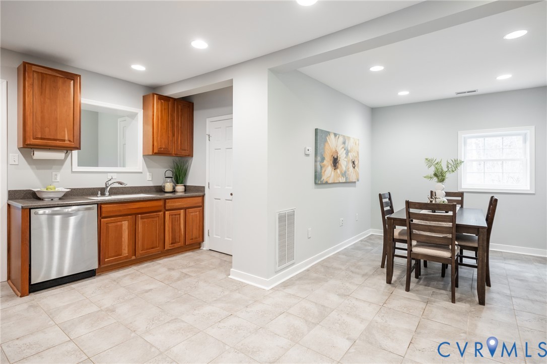 795 Snead Road Manakin-Sabot, VA 23103 - Photo 20 of 31 a kitchen with granite countertop a stove a sink a dining table and chairs