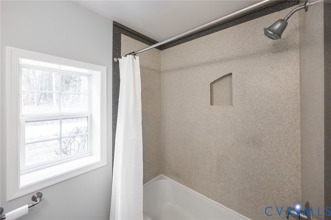 795 Snead Road Manakin-Sabot, VA 23103 - Photo 27 of 31 a bathroom with a bathtub and a shower
