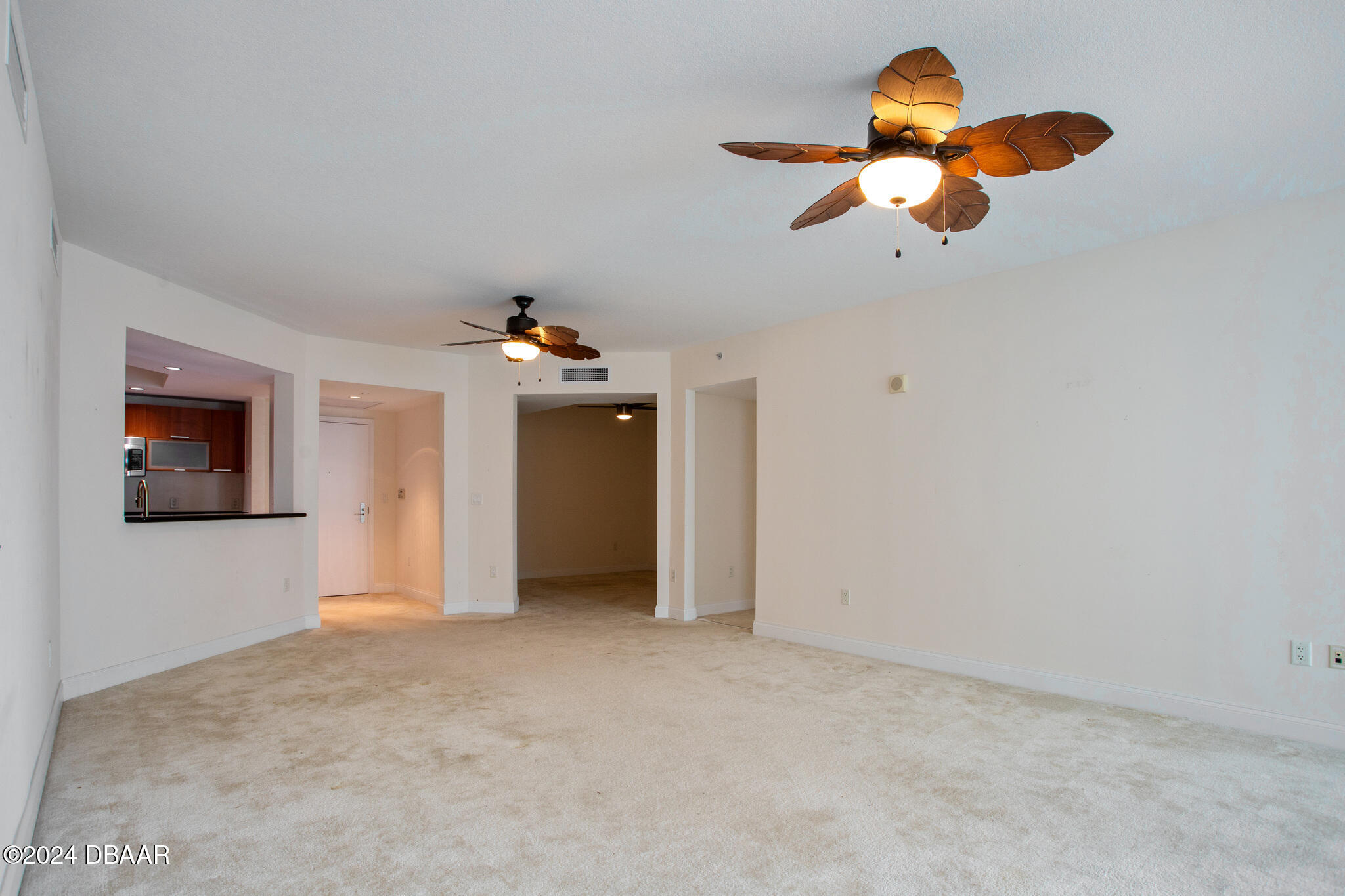 241 Riverside Drive Daytona Beach, FL 32117 - Photo 2 of 20 a view of a room with a chandelier fan and wooden floor