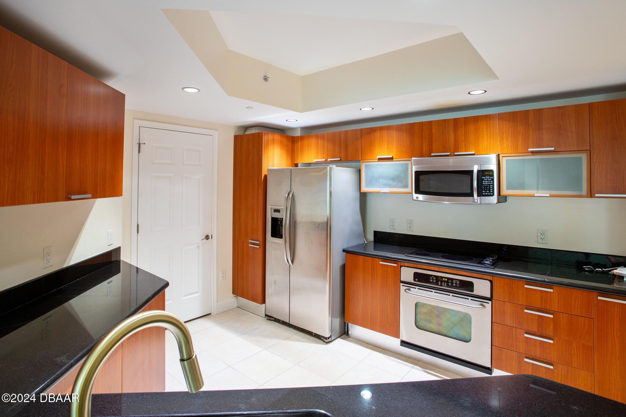 241 Riverside Drive Daytona Beach, FL 32117 - Photo 3 of 20 a kitchen with stainless steel appliances granite countertop a stove a sink and a microwave