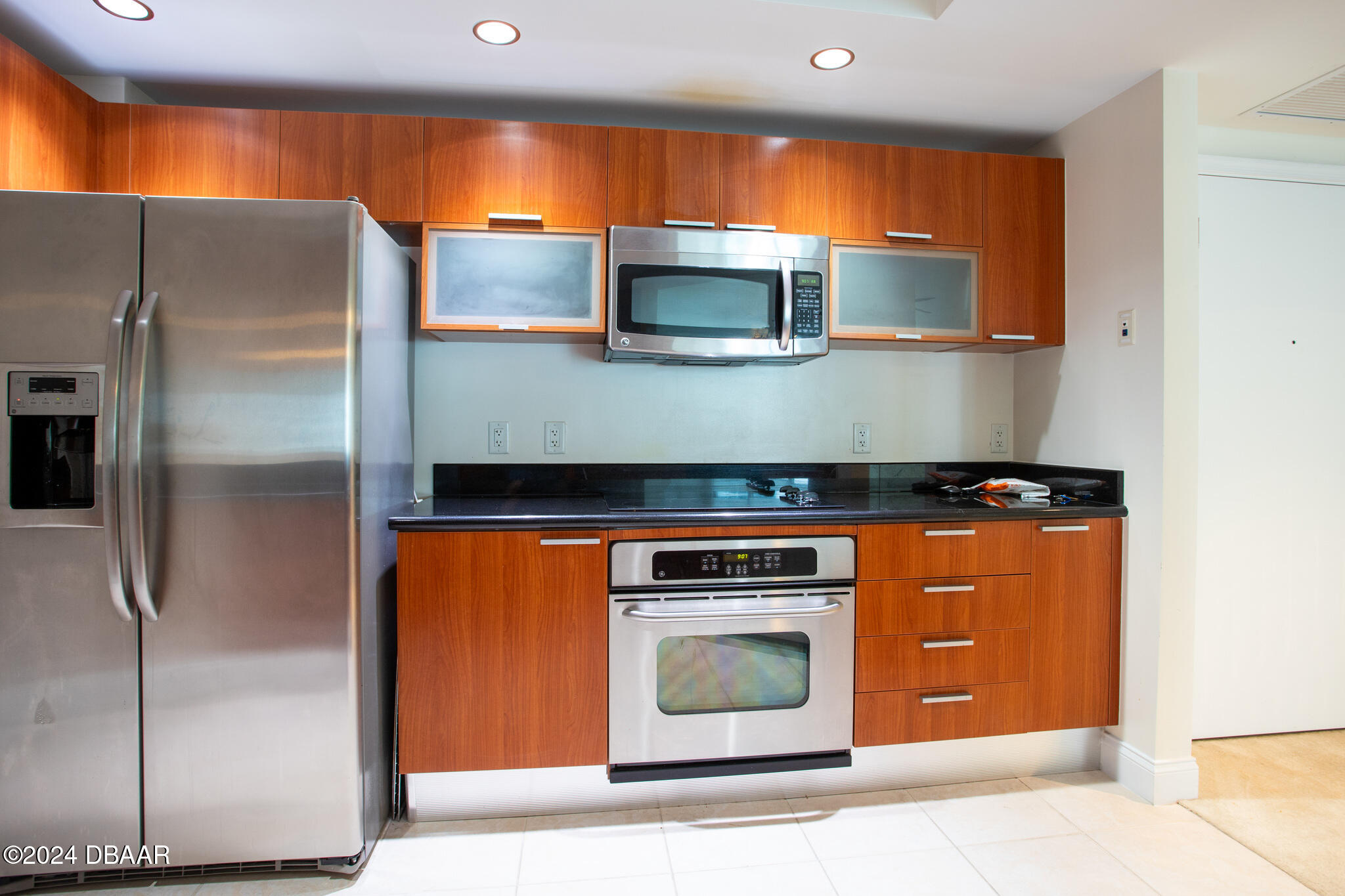 241 Riverside Drive Daytona Beach, FL 32117 - Photo 4 of 20 a kitchen with stainless steel appliances granite countertop a refrigerator and a stove