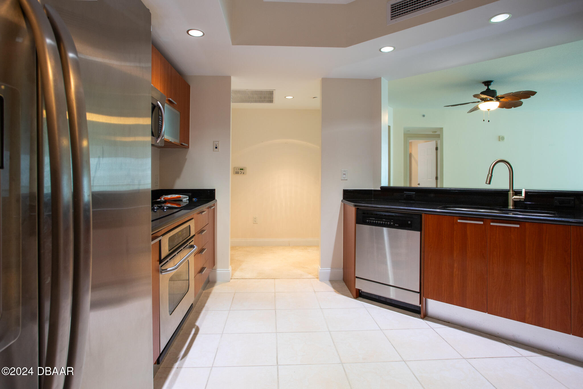 241 Riverside Drive Daytona Beach, FL 32117 - Photo 6 of 20 a kitchen with stainless steel appliances granite countertop a refrigerator and a sink