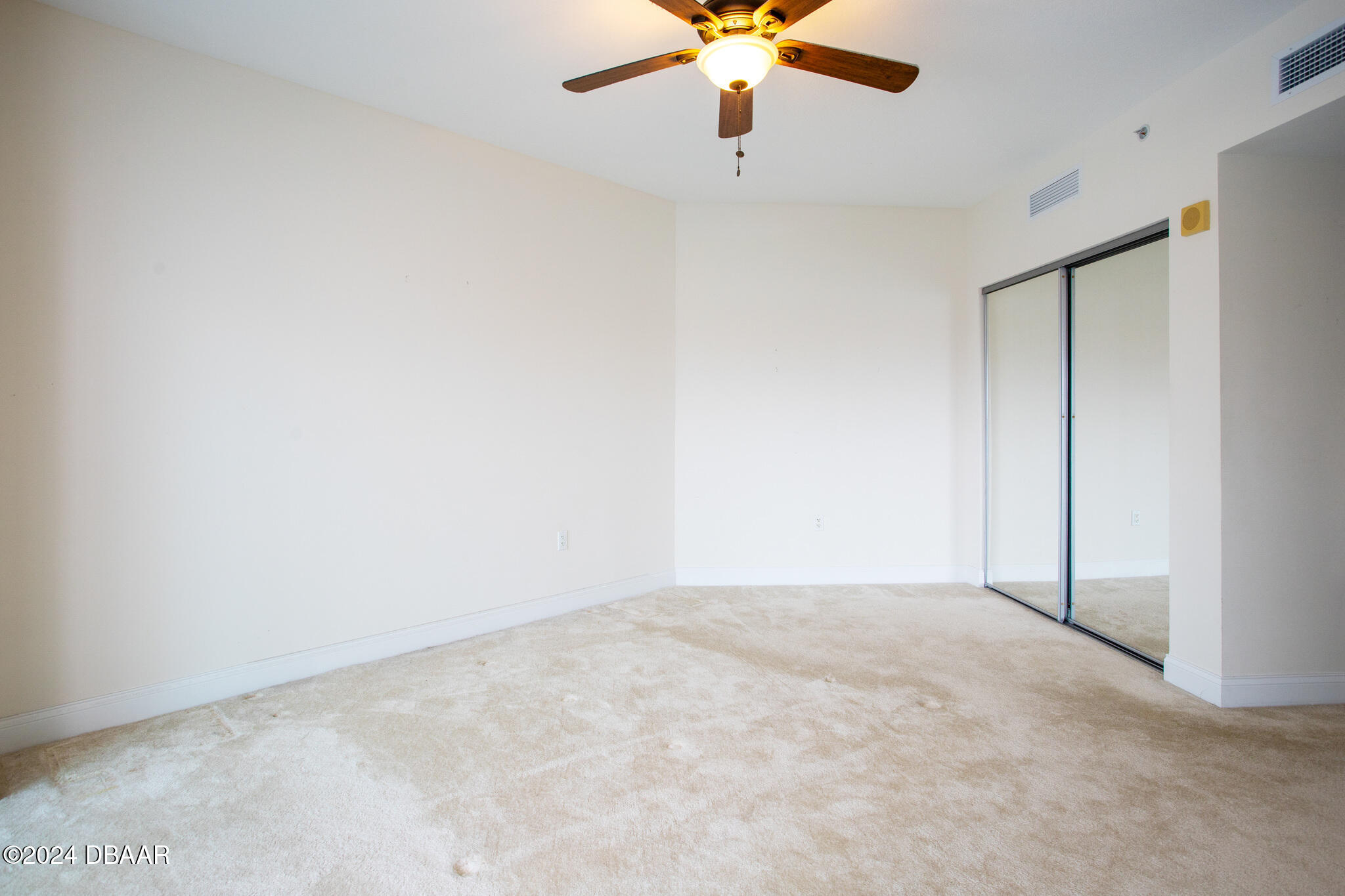 241 Riverside Drive Daytona Beach, FL 32117 - Photo 9 of 20 an empty room with a chandelier fan