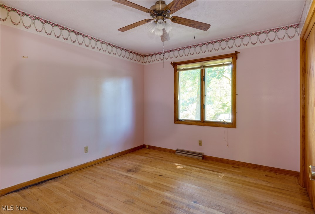3433 Greenwich Road Barberton, OH 44203 - Photo 20 of 41 Bedroom #3 has a hardwood floor, a ceiling fan and a large closet.