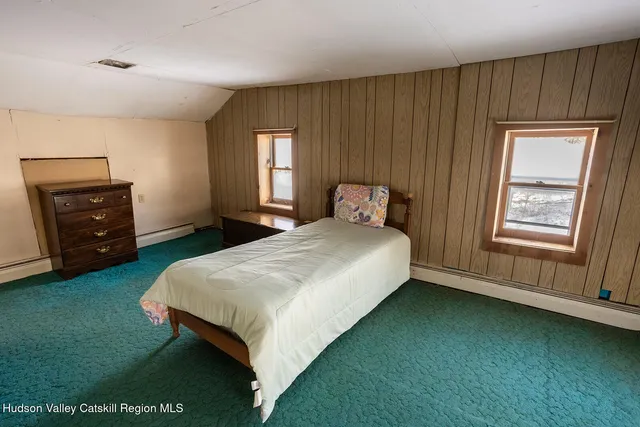 a bedroom with a bed and a closet