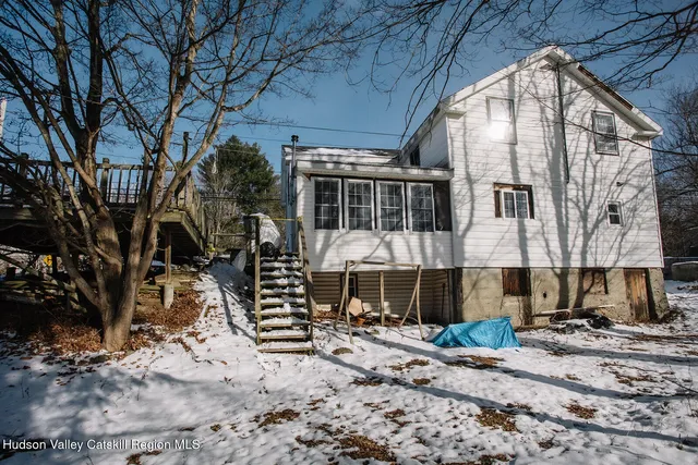 a front view of a house with yard and seating area