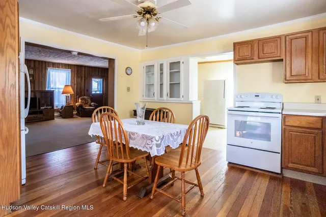 a view of a dining room with furniture window and wooden floor
