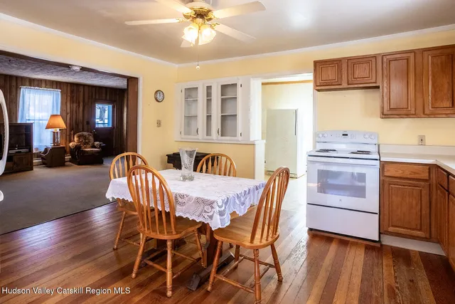 a view of a dining room with furniture and chandelier