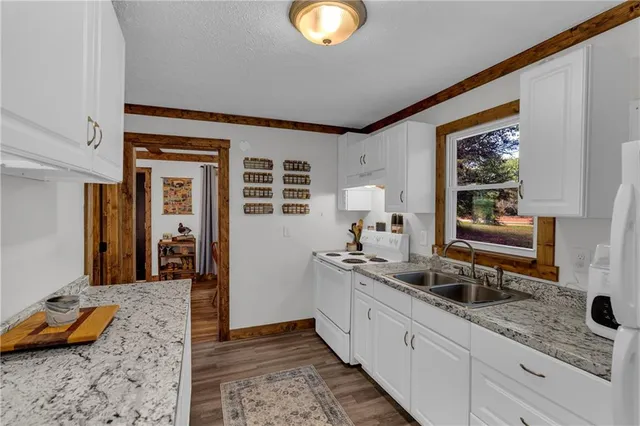 a kitchen with stainless steel appliances granite countertop a sink and cabinets