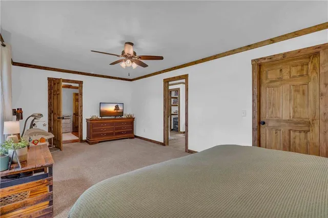 a living room with furniture a ceiling fan and a window