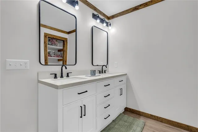 a bathroom with a double vanity sink and a mirror