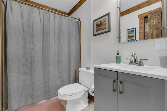 a bathroom with a sink mirror and toilet