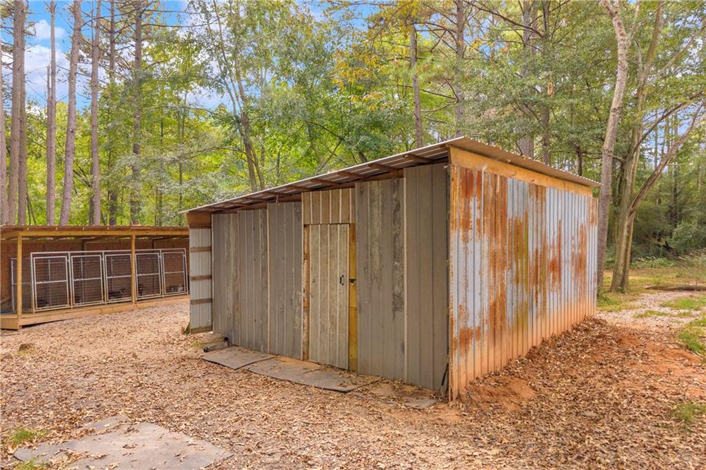 1334 Joe Bolton Road Commerce, GA 30530 - Photo 41 of 45 a backyard of a house with a large tree and wooden fence