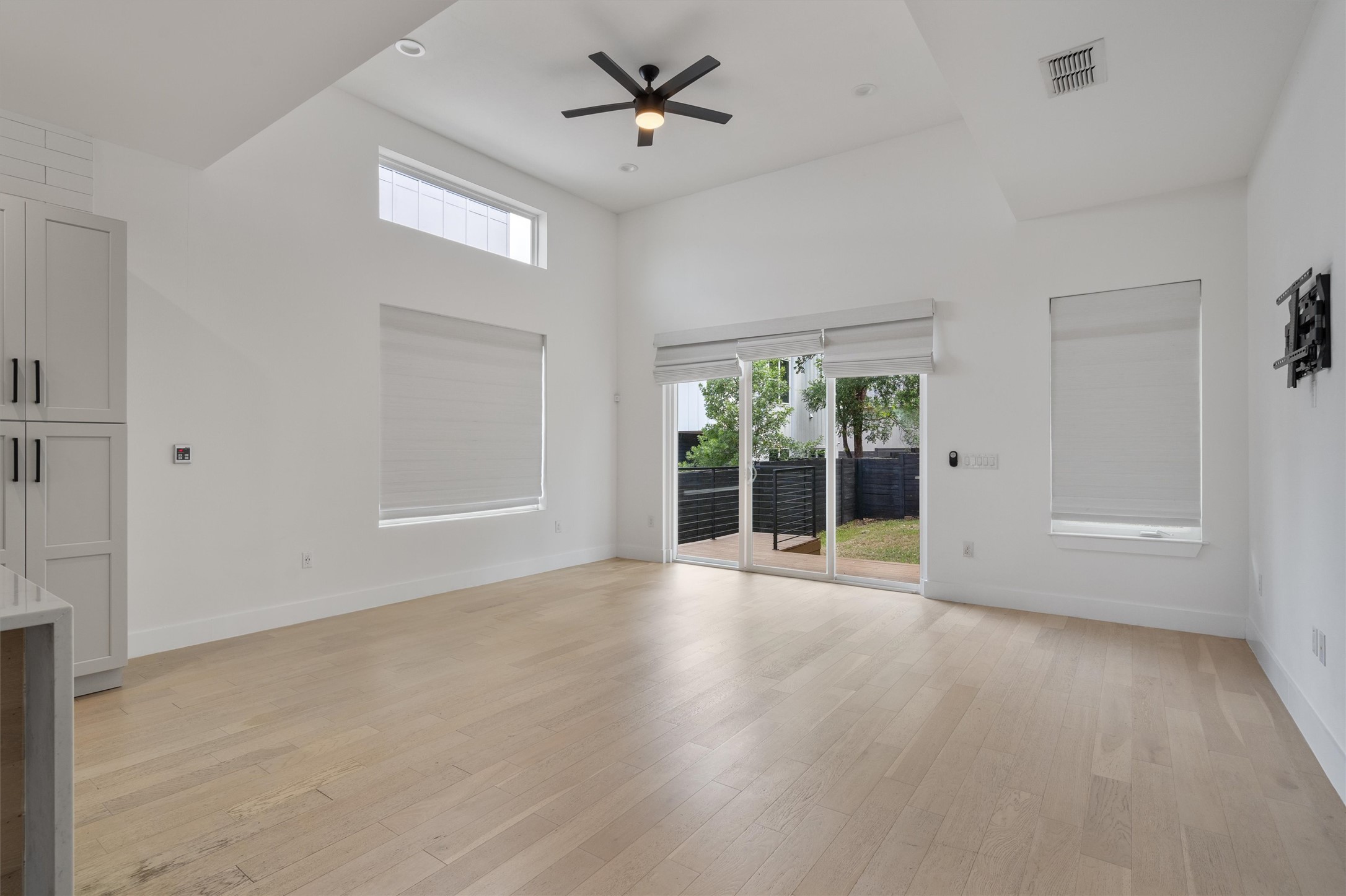 4712 Reyes Street, Unit 1 Austin, TX 78721 - Photo 6 of 38 an empty room with wooden floor and windows