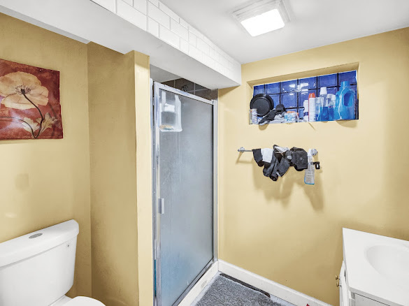 10748 S Avenue North Chicago, IL 60617 - Photo 11 of 19 a bathroom with a shower and a toilet