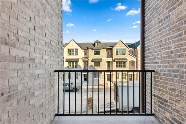 a view of a brick house with a small yard