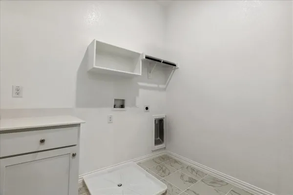 a view of storage and utility room with closet