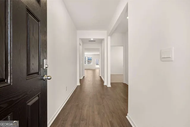 a view of a hallway with wooden floor