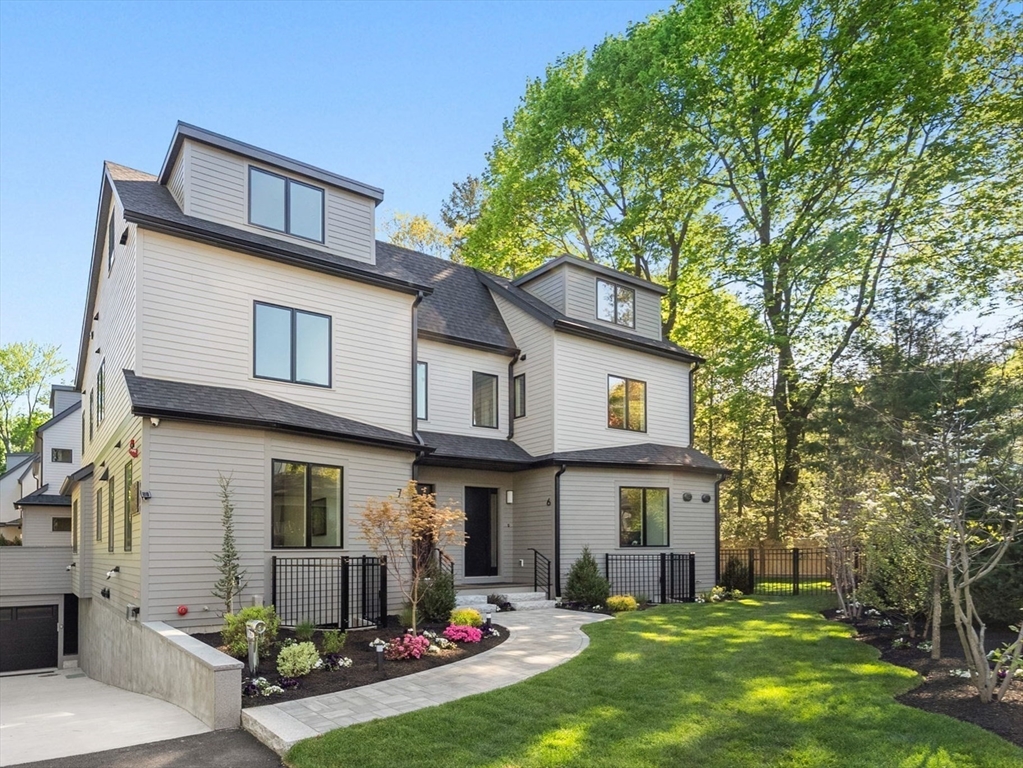 956 Walnut Street, Unit 7 Newton, MA 02461 - Photo 1 of 33 a view of a white house with large windows and a yard with plants and large trees
