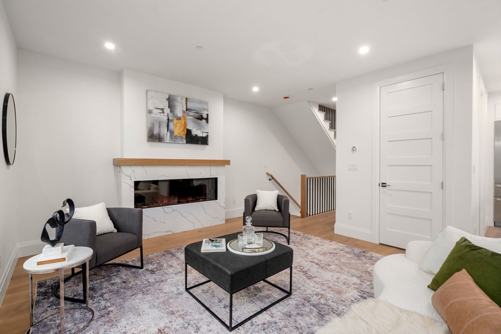 956 Walnut Street, Unit 7 Newton, MA 02461 - Photo 12 of 33 a living room with furniture and a fireplace