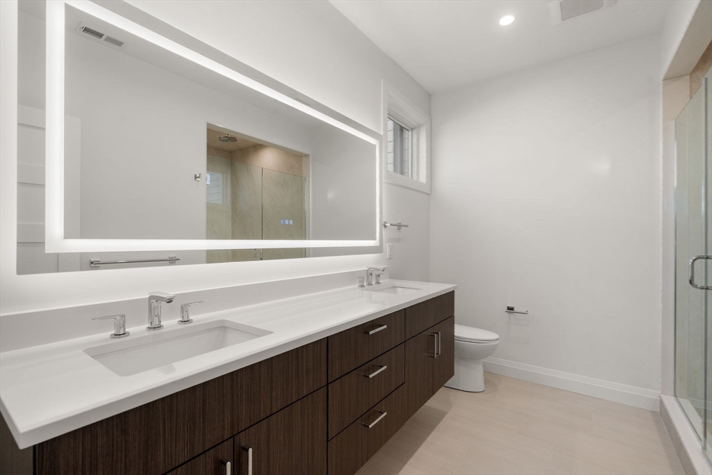 956 Walnut Street, Unit 7 Newton, MA 02461 - Photo 16 of 33 a bathroom with a double vanity sink and a mirror