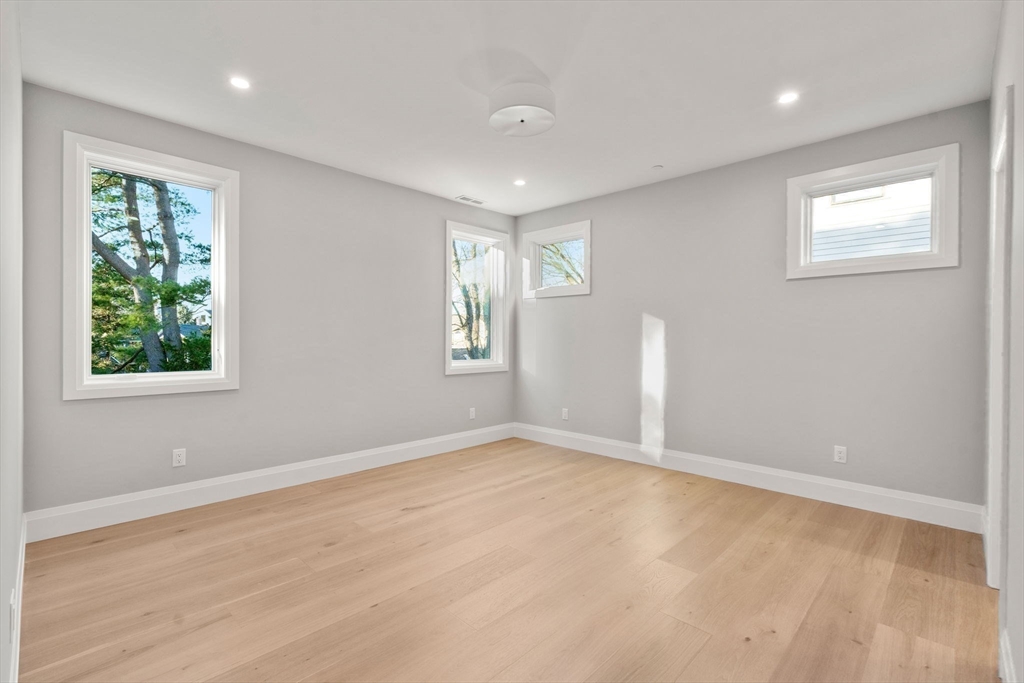 956 Walnut Street, Unit 7 Newton, MA 02461 - Photo 18 of 33 an empty room with windows and closet