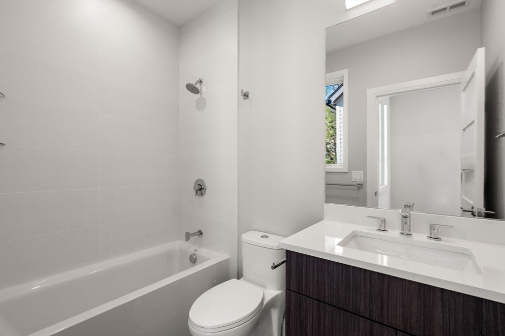 956 Walnut Street, Unit 7 Newton, MA 02461 - Photo 21 of 33 a bathroom with a sink toilet a bathtub and vanity