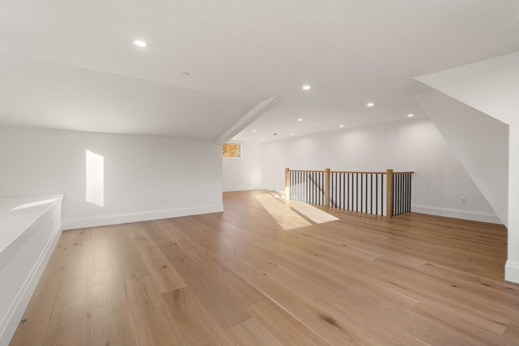 956 Walnut Street, Unit 7 Newton, MA 02461 - Photo 23 of 33 a view of an empty room with wooden floor and a window