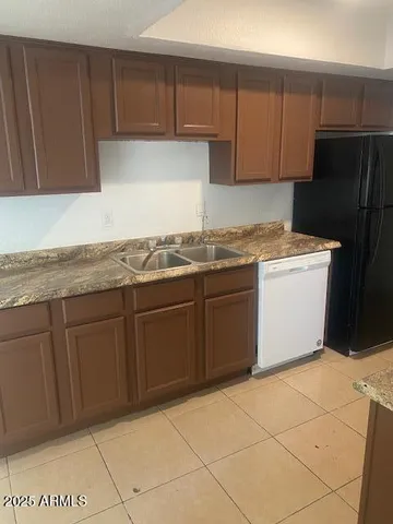 a kitchen with stainless steel appliances granite countertop a stove a refrigerator and a cabinets