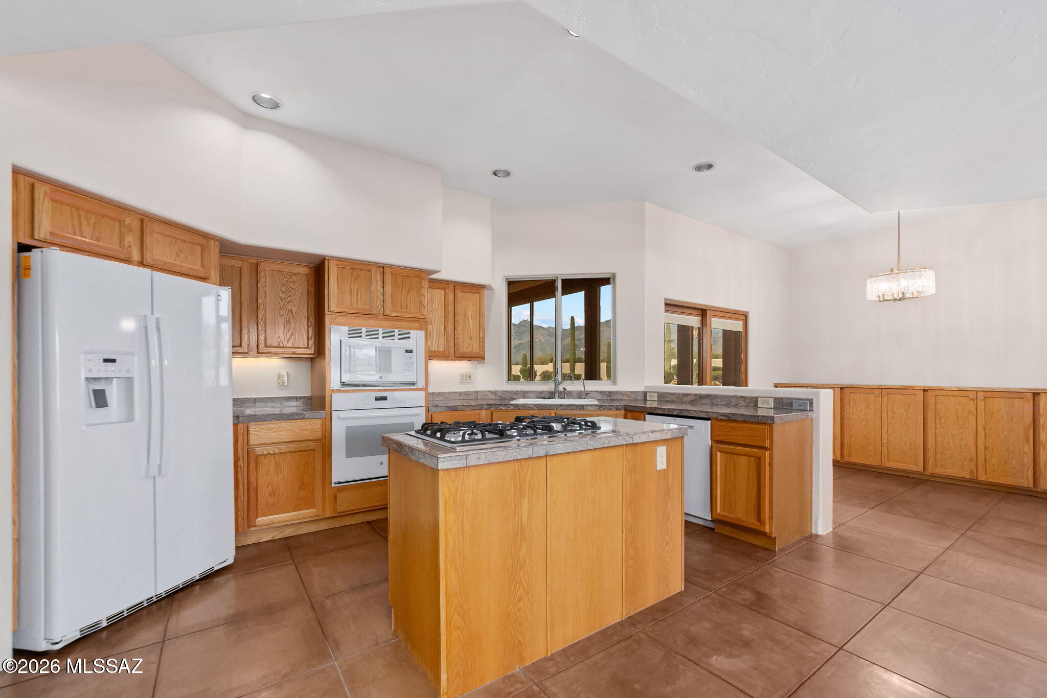 3655 North Harrison Road Tucson, AZ 85749 - Photo 16 of 51 a kitchen with stainless steel appliances granite countertop a refrigerator a stove and a sink