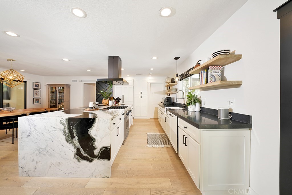13862 Gimbert Lane North Tustin, CA 92705 - Photo 13 of 63 a kitchen with stainless steel appliances kitchen island granite countertop a sink and stove