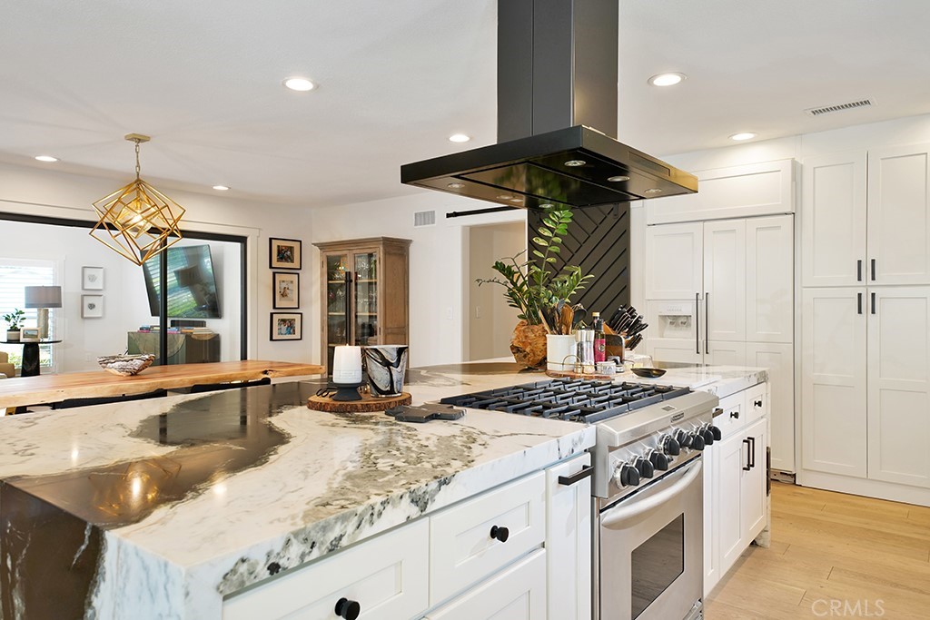 13862 Gimbert Lane North Tustin, CA 92705 - Photo 14 of 63 a kitchen with a stove and a chandelier