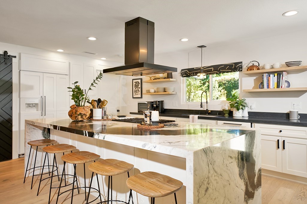 13862 Gimbert Lane North Tustin, CA 92705 - Photo 15 of 63 a kitchen with stainless steel appliances granite countertop a stove a sink and a dining table with white cabinets