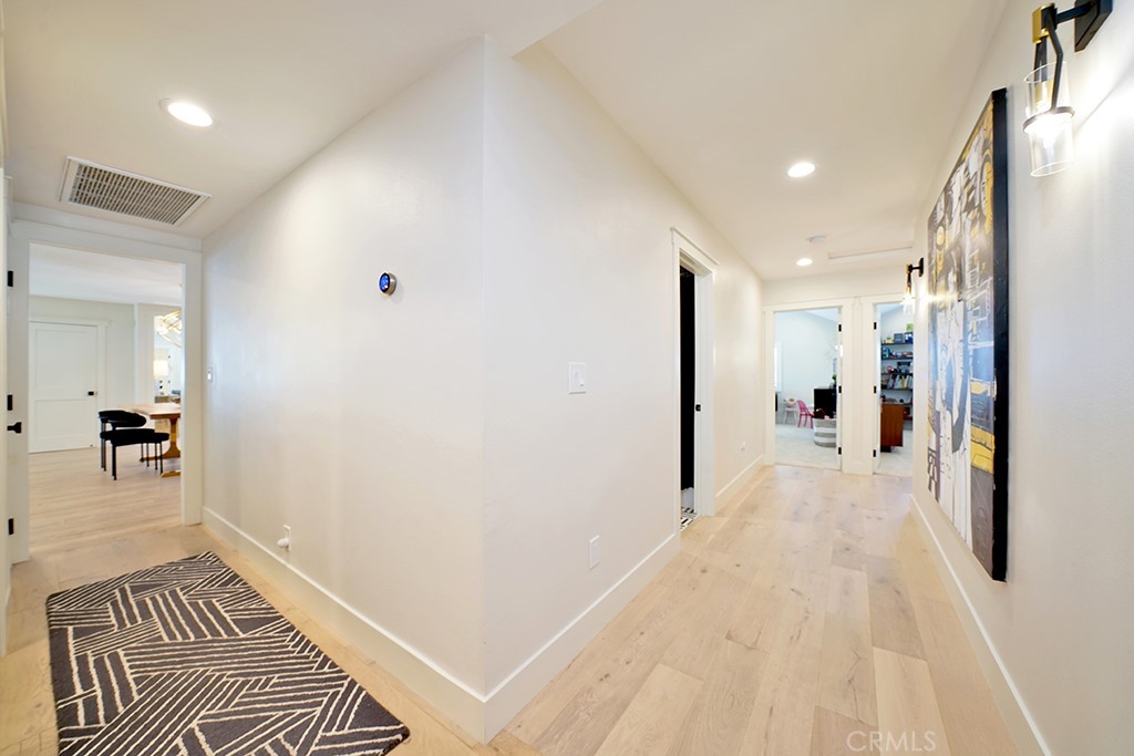 13862 Gimbert Lane North Tustin, CA 92705 - Photo 32 of 63 a view of a hallway with wooden floor and a living room