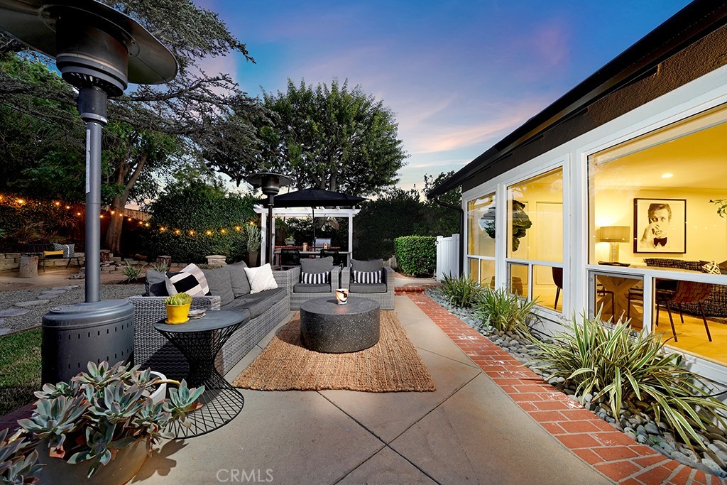 13862 Gimbert Lane North Tustin, CA 92705 - Photo 40 of 63 a view of a patio with couches table and chairs and potted plants