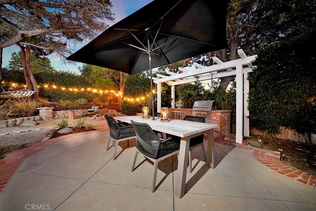 13862 Gimbert Lane North Tustin, CA 92705 - Photo 45 of 63 a view of patio with a table and chairs under an umbrella