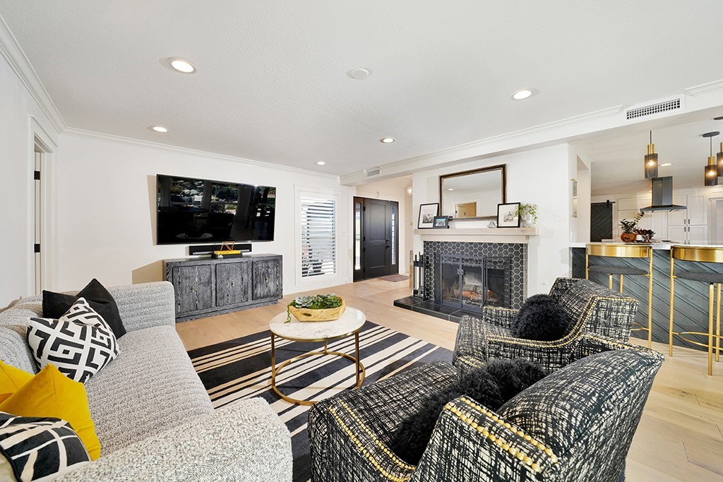 13862 Gimbert Lane North Tustin, CA 92705 - Photo 5 of 63 a living room with furniture a flat screen tv and a fireplace