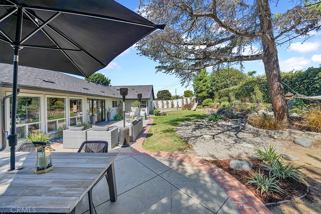 13862 Gimbert Lane North Tustin, CA 92705 - Photo 53 of 63 a view of patio with table and chairs under an umbrella