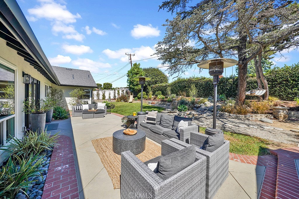 13862 Gimbert Lane North Tustin, CA 92705 - Photo 57 of 63 a view of a patio with couches and table and chairs and potted plants