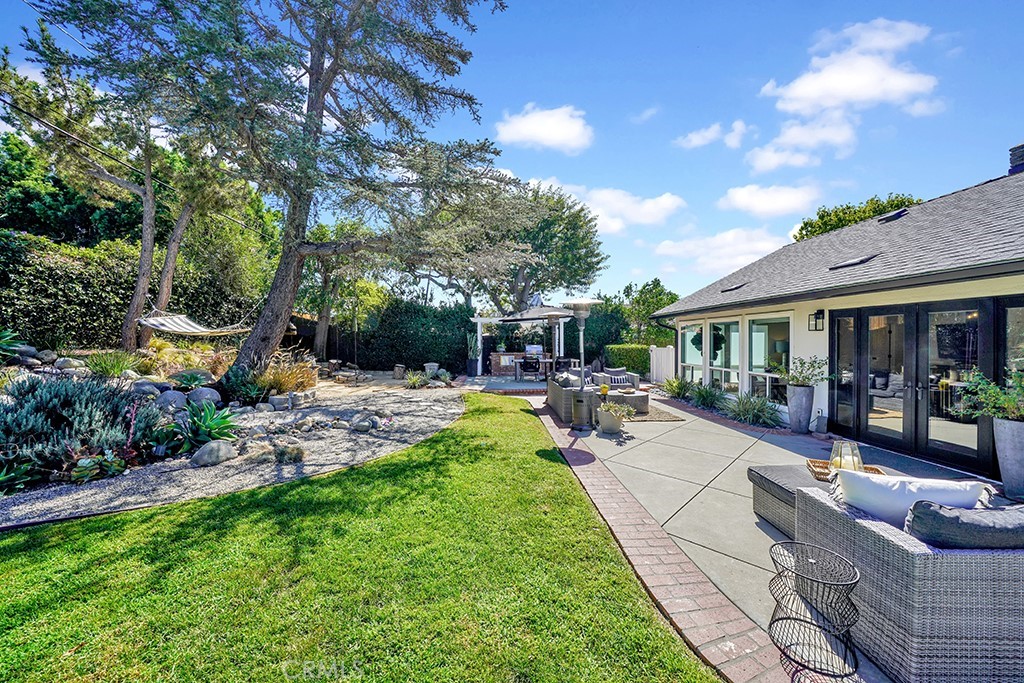 13862 Gimbert Lane North Tustin, CA 92705 - Photo 63 of 63 a view of a patio with couches and table and chairs with plants and trees