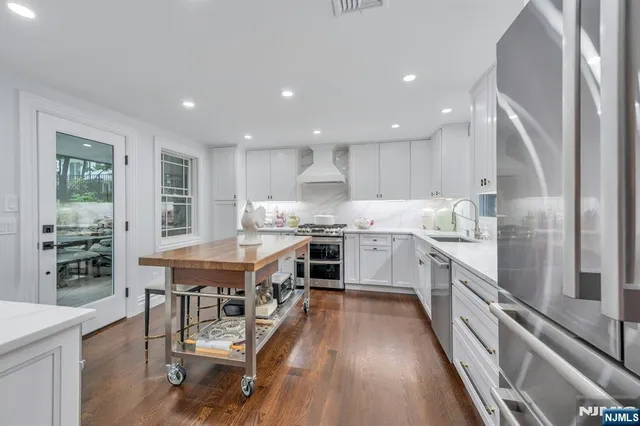 a view of a patio with couches and a table and chairs with wooden fence